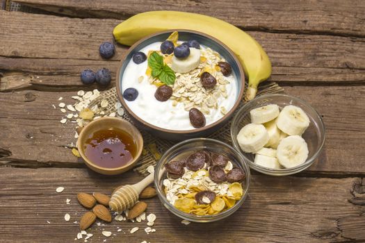 healthy breakfast - muesli with fruit, yogurt and honey