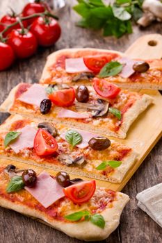 Homemade pizza with fresh tomatoes olives and mushrooms