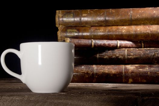 Old books and white cup