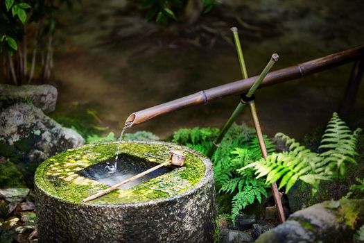Traditional japanese bamboo fountain at Ryoan-ji temple in Kyoto, Japan