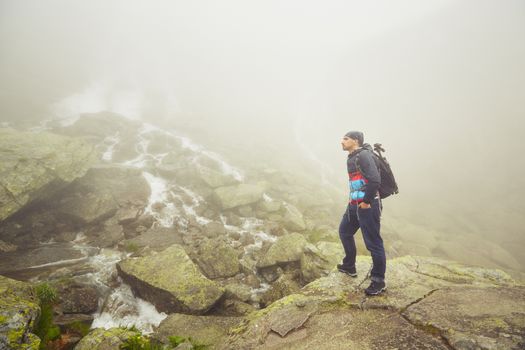 Traveler in thick fog in the mountains.