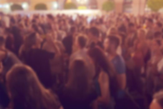 Unrecognizable crowd of young people at outdoor summer party
