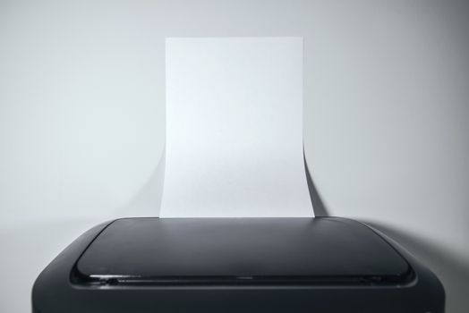 Office desktop laser printer with blank paper as copy space