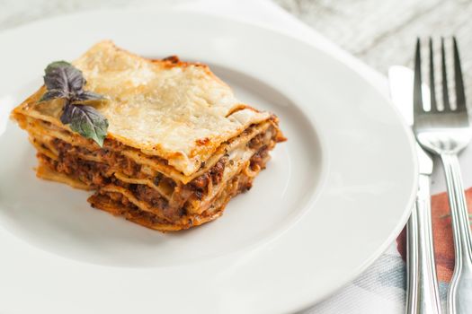 portion of lasagne bolognese on a white plate