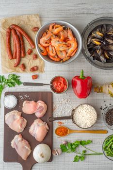Ingredients for paella on the white  table vertical