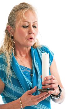 Attractive blonde woman blowing out a candle.