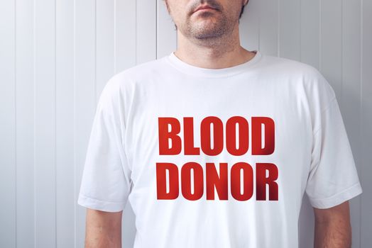Blood donor wearing white t-shirt