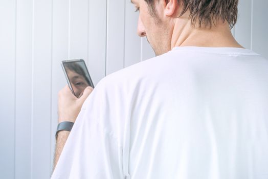 Guy using mobile phone from behind