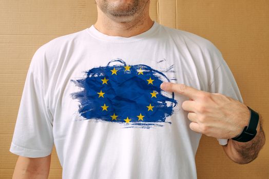 Handsome man proudly wearing white shirt with EU flag