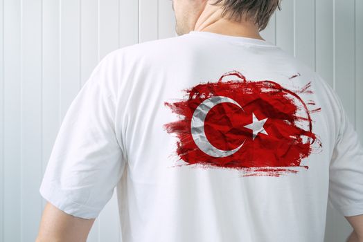 Man wearing white shirt with Turkey flag print