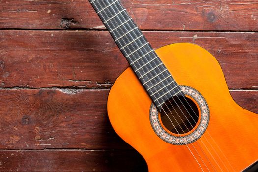 Flamenco guitar on wooden background