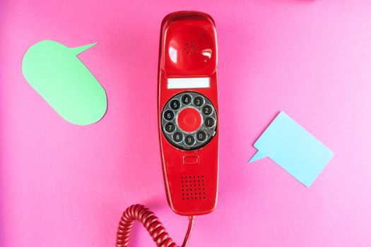 Vintage red phone and speech ballons