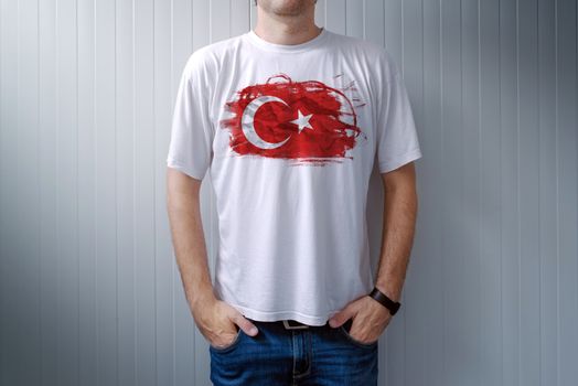 Man wearing white shirt with Turkey flag print