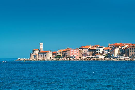 Picturesque old town Piran on Slovenian adriatic coast, shot from sailing boat on sunny summer day