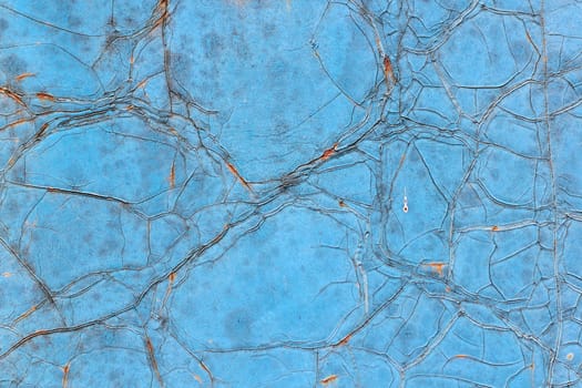 the iron wall with rust and cracked blue paint