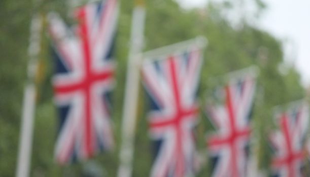 Many defocussed Union Jack flags background copy space