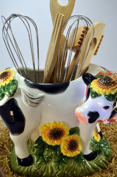 Distort cow with the hollow back and the kitchen utensils