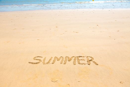 Summer word written on sand