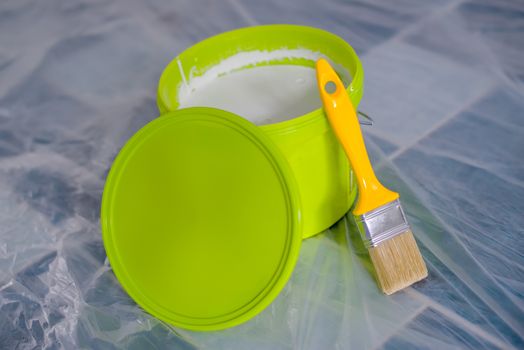 Yellow paint brush and green bucket
