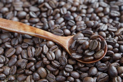 Roasted coffee beans and wooden spoon