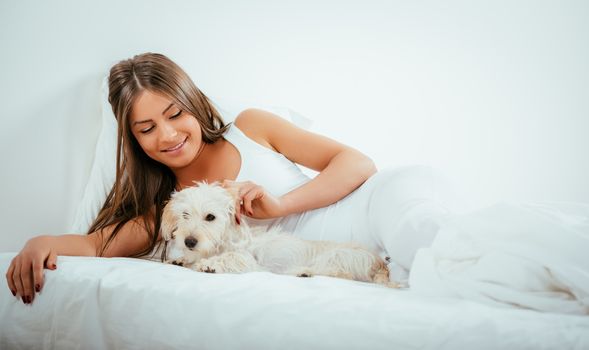 Girl And Dog In Bed