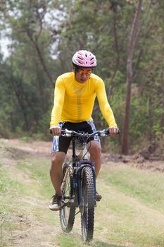 man and mountain bike riding in jungle track use for bicycle spo