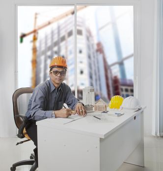 architect engineer working in office room against building const