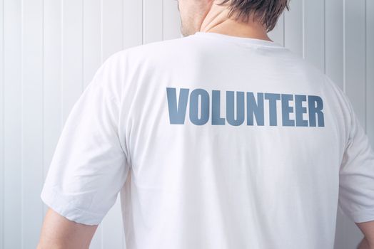 Guy wearing shirt with Volunteer label printed on back