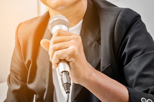 Businessman making speech with microphone.