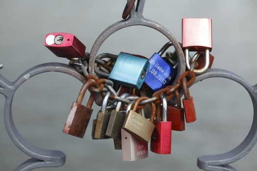 Love locks hanging on a Metal fence of a Bridge