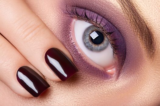 Eye makeup and manicure.