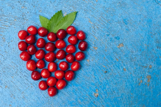 Heart shaped cherries on blue background cherry heart
