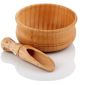 Wooden bowl with a shovel for spices on a white background