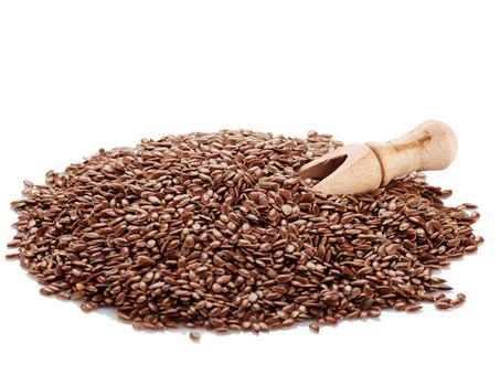 Flax seeds and shovel spice on a white background