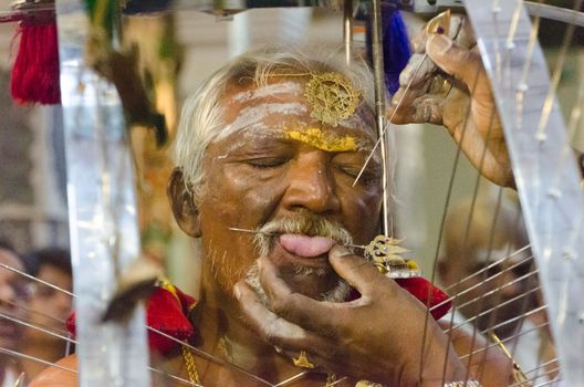 Hindu devotee piercing tongue for Thaipsam