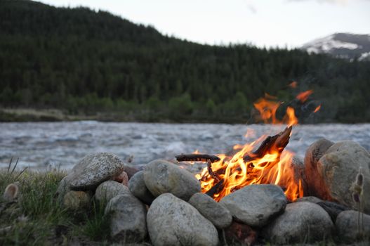 small campfire between rocks