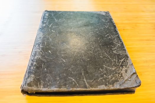 old closed book on wooden table