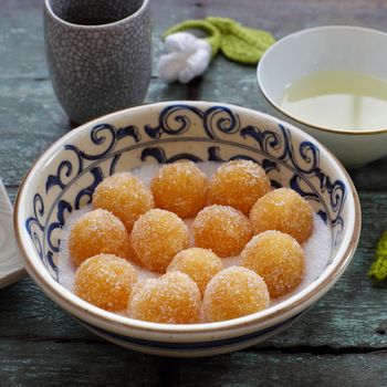 Vietnamese sweet food for tet holiday, home made pineapple jam in ball on wooden background, a traditional eating for lunar new year in Vietnam