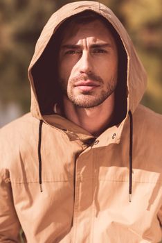 Handsome man in jacket with hood