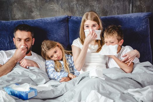 Sick family on bed