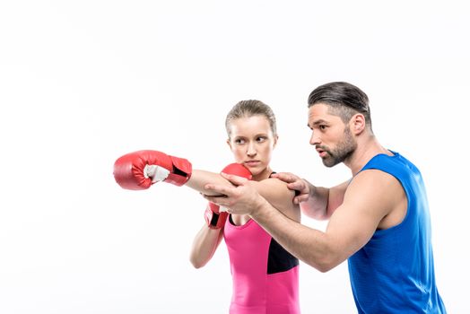 Girl practicing boxing with trainer