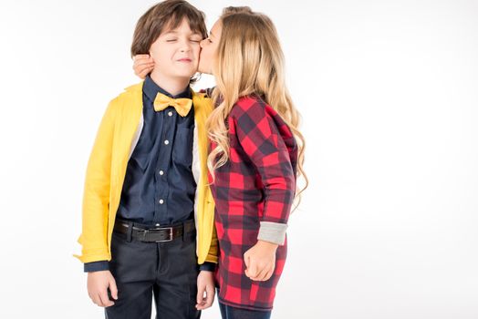 Schoolgirl kissing in cheek schoolboy
