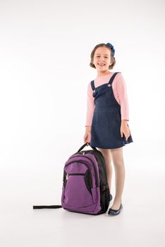 Schoolgirl standing with backpack