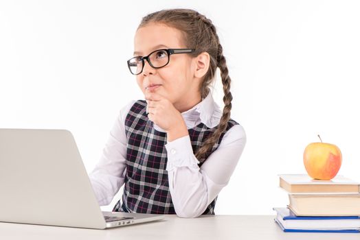 Schoolgirl at desk with laptop