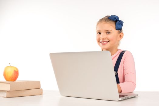 Smiling schoolgirl with laptop