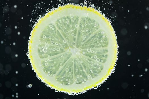 Lemon slice diving into water
