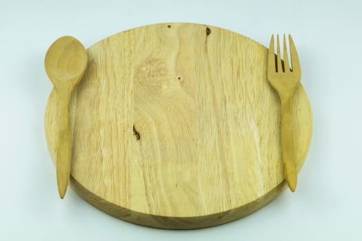 wood cutting board with spoon and fork on white background