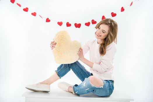 Woman with heart shaped pillow    