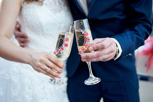 bride and groom are holding champagne glasses