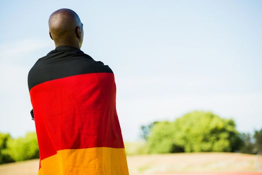 Athlete with german flag wrapped around his body